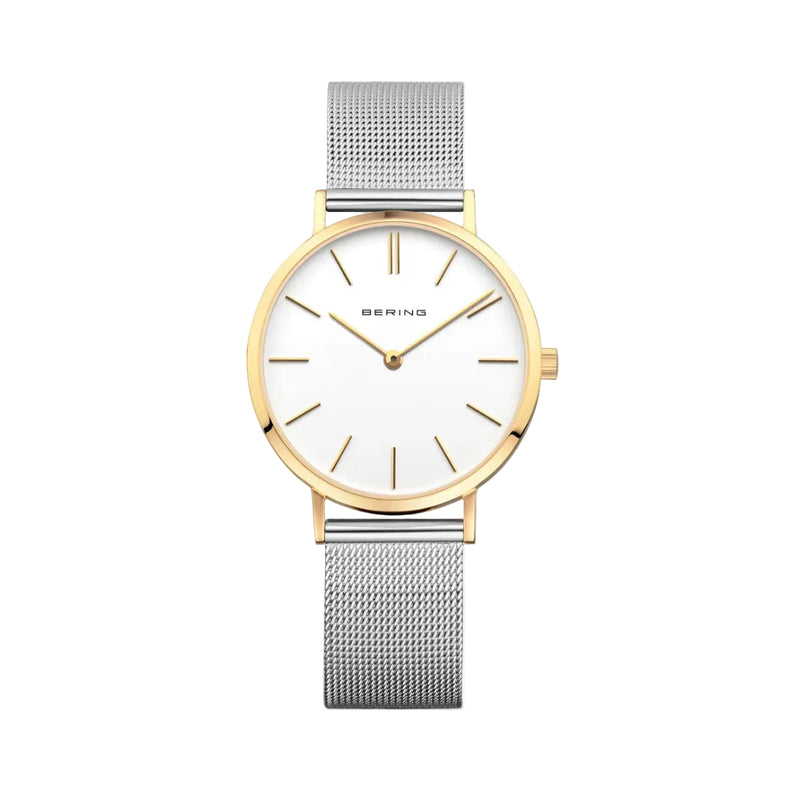 A Bering Classic Collection watch with a polished gold case and a silver strap, featuring a white dial with gold markers.
