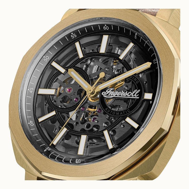 Gold wristwatch with a transparent face displaying mechanical components on a white background