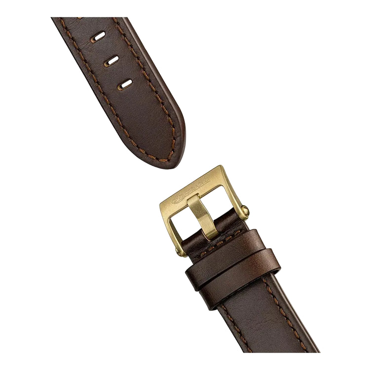 Brown leather watch strap with gold buckle on a white background