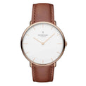 A rose gold-colored watch with a white dial and a brown leather strap, featuring markings and a logo on the face.