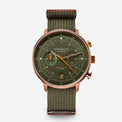 Sternglas London chronograph watch with an olive green dial and matching green canvas strap, featuring a rose gold-toned case and orange accents.