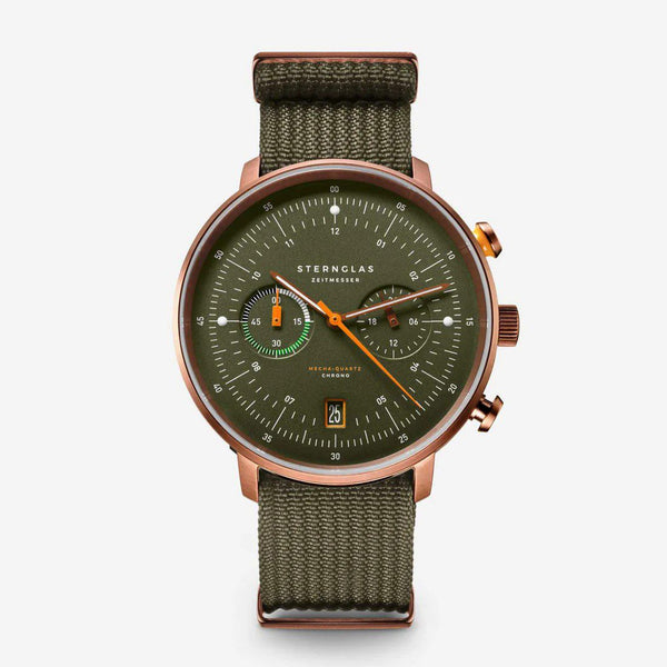 Sternglas London chronograph watch with an olive green dial and matching green canvas strap, featuring a rose gold-toned case and orange accents.