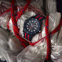 Wristwatch with red and blue strap on a white background