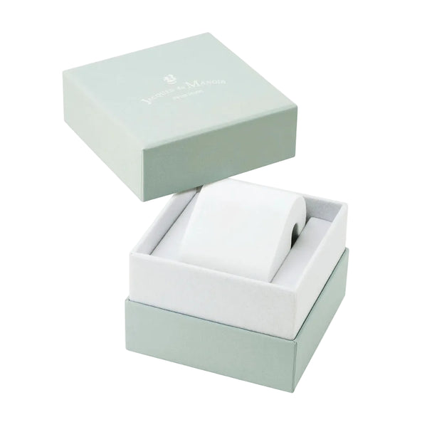 A white cylindrical watch or accessory roll displayed inside an open square presentation box with a pale mint green lid resting above it on a white background.