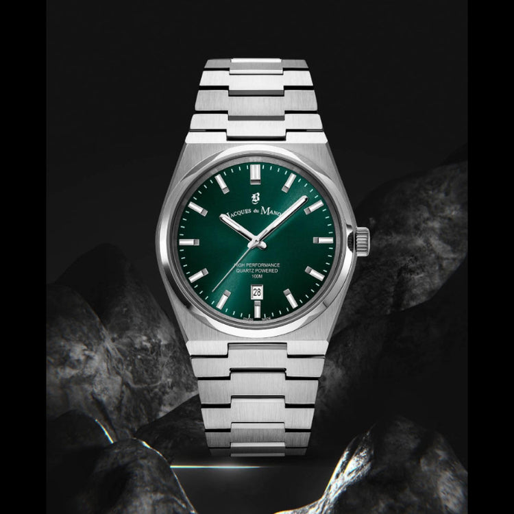 Silver watch with a green dial on a dark background