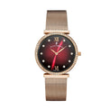 A women's watch by Jeanne-Marie with a rose gold mesh strap, a crystal-studded bezel, and a dark red-to-black sunburst dial with gold-tone Roman numerals and hands.