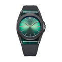 A minimalist wristwatch with a dark gray matte case, a green gradient dial, and a matching green and black textured strap, shown against a plain white background.
