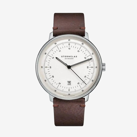 Sternglas watch with a brown leather strap, silver-toned case, and a white dial with black markings and hands, shown against a plain white background.
